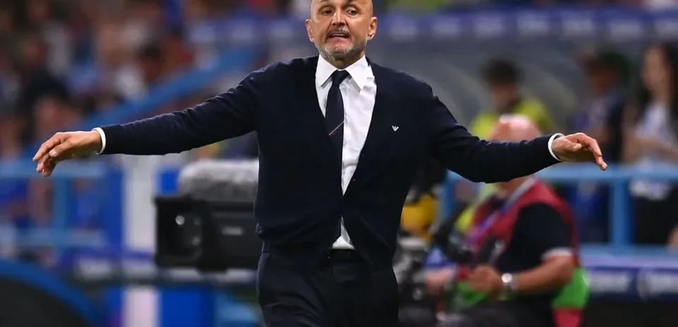 Coach gesturing during a football match on the sidelines