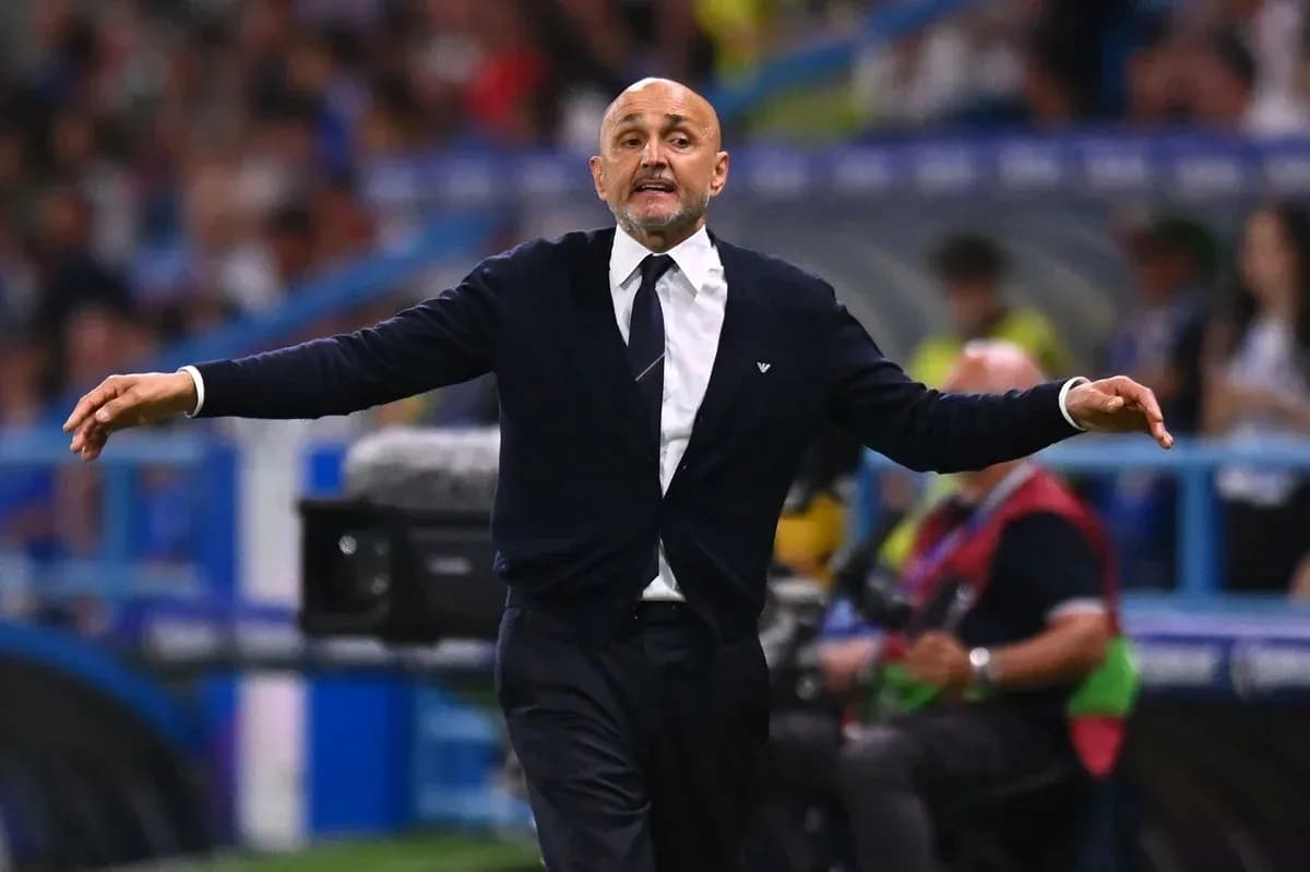 Coach gesturing during a football match on the sidelines
