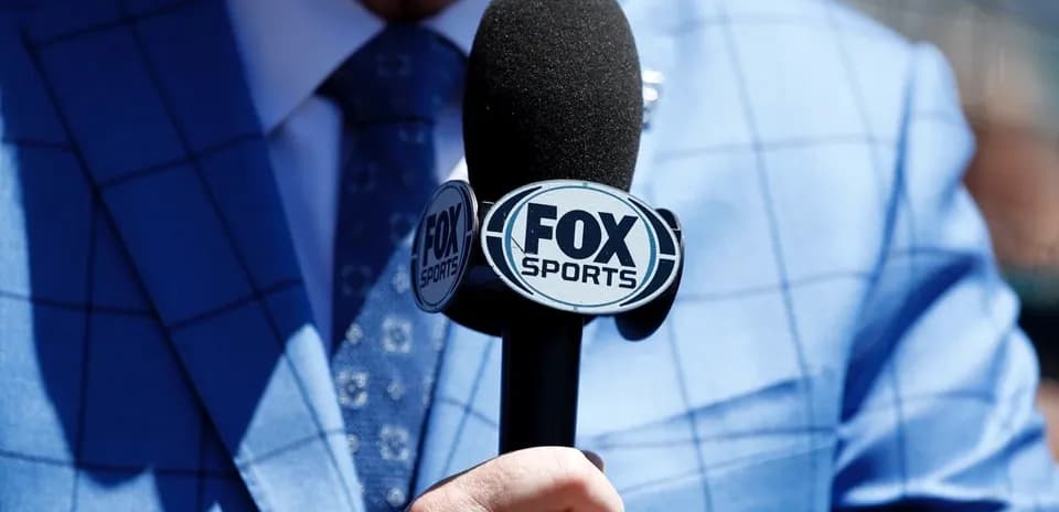 Microphone with FOX Sports logo held by presenter