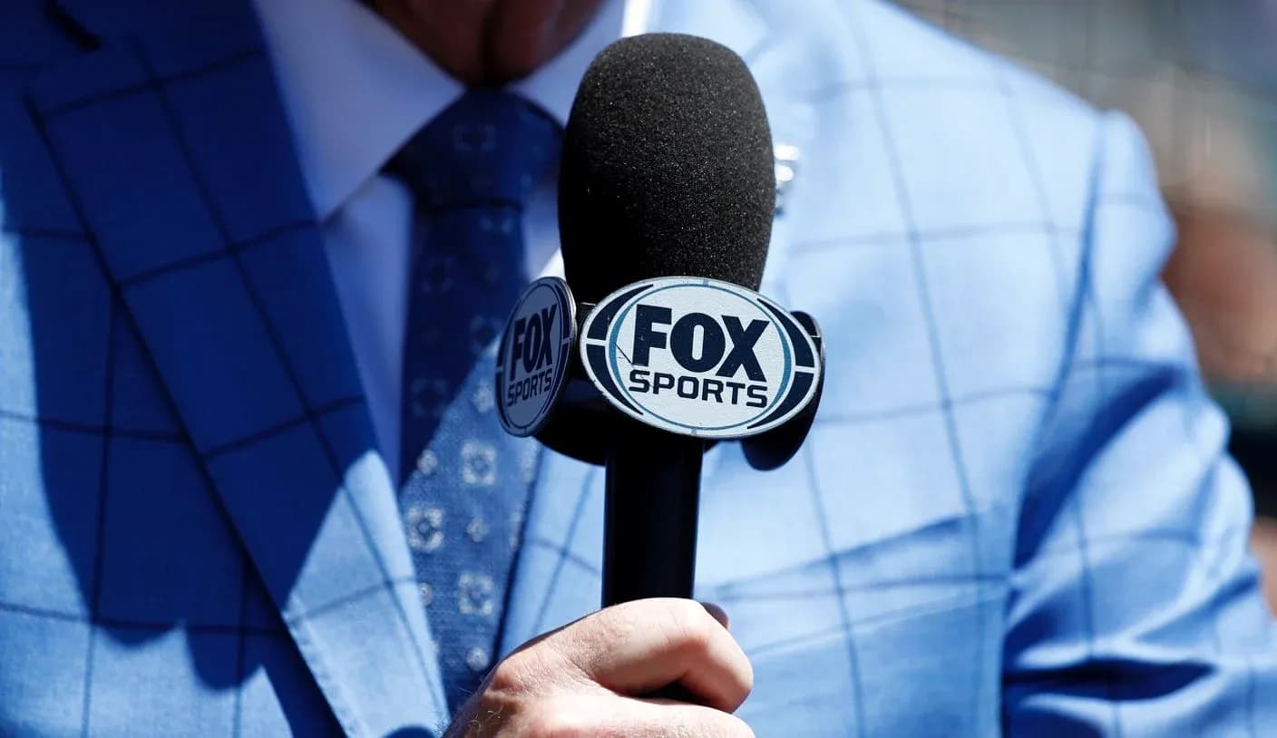 Microphone with FOX Sports logo held by presenter