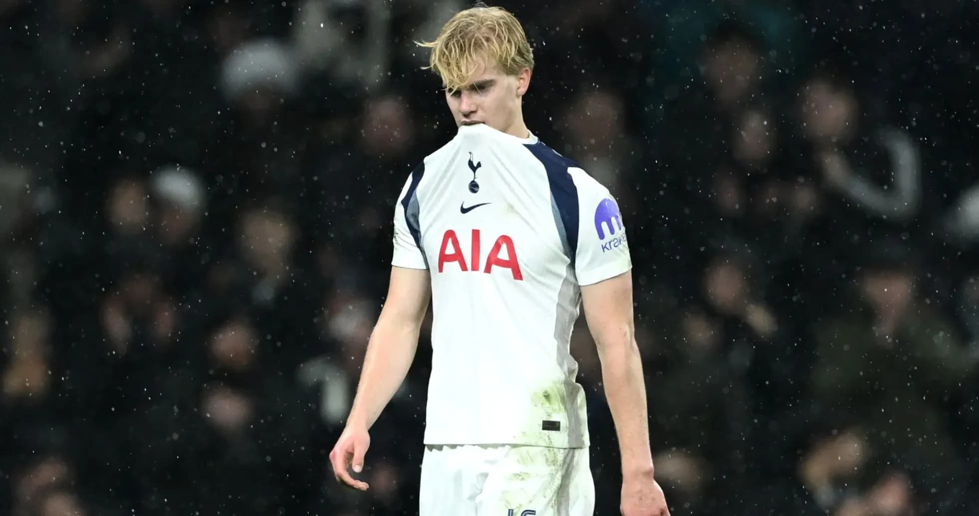 Tottenham player looking down during rainy match