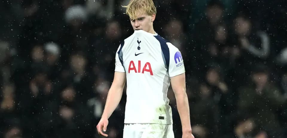 Tottenham player looking down during rainy match