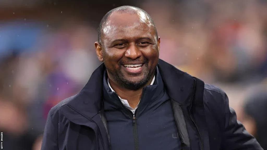 Coach smiling during a football match
