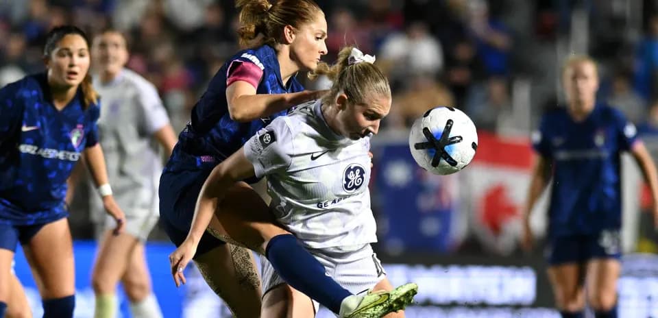 Players competing for the ball in NWSL match