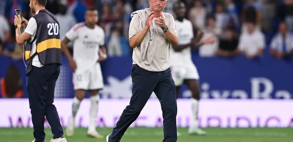 Manager clapping during a football match