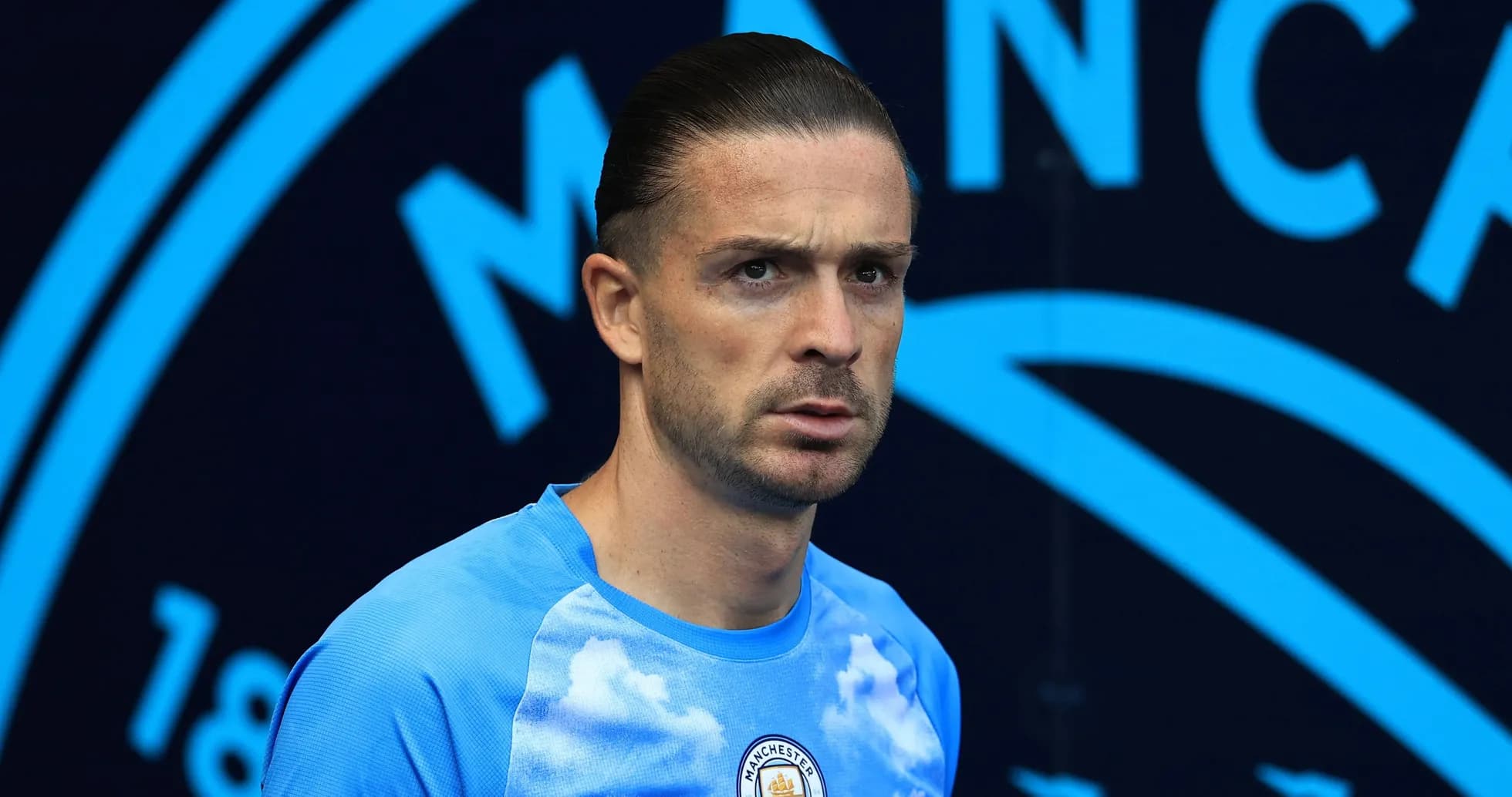 Player in Manchester City training kit posing for photo