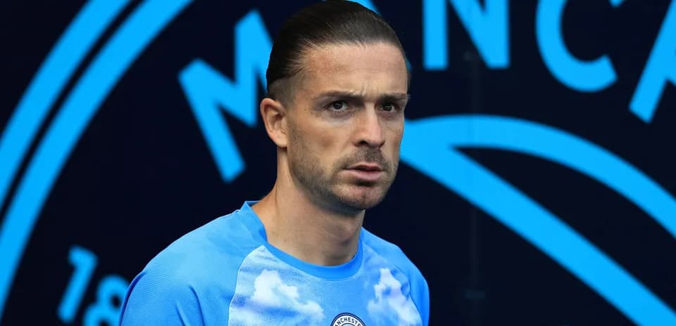 Player in Manchester City training kit posing for photo