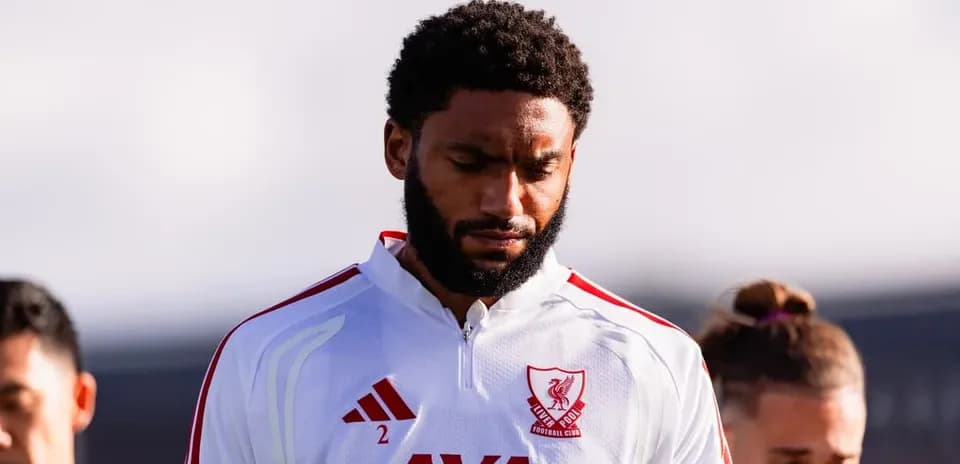 Player in Liverpool FC kit during team moment
