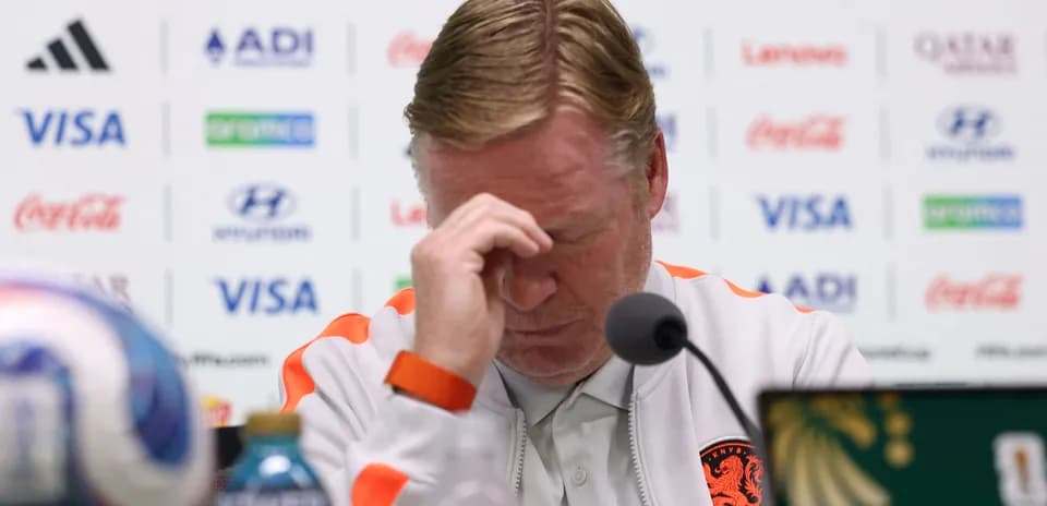 Manager at press conference with head down