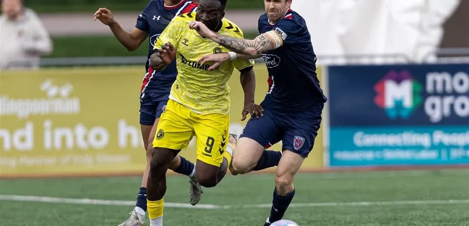 Pittsburgh Riverhounds player challenged by Indy Eleven defenders