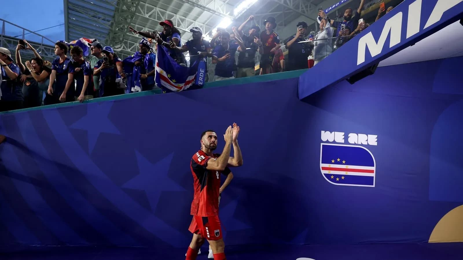 Player applauding fans after match at stadium