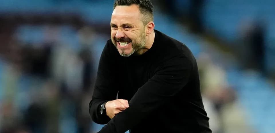 Coach celebrating during a match on the sidelines
