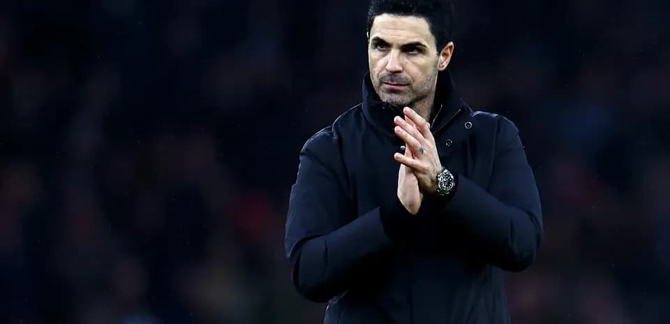 Manager applauding fans during a match