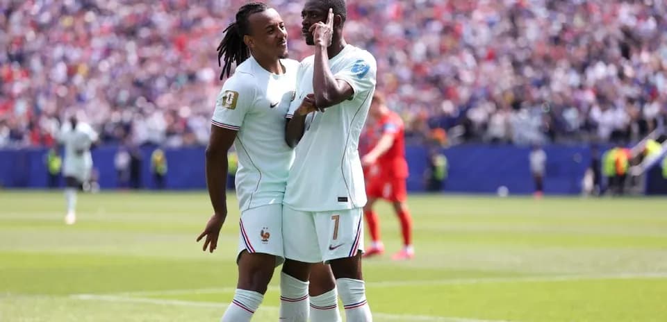 Two players celebrating a goal on the field