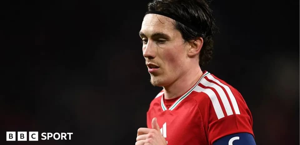 Player wearing captain's armband in red jersey