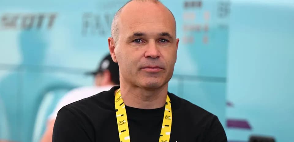 Man with a lanyard at cycling event backdrop