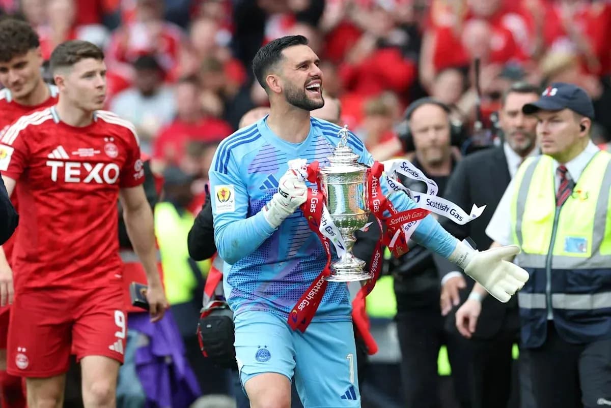 Goalkeeper celebrating with trophy after match