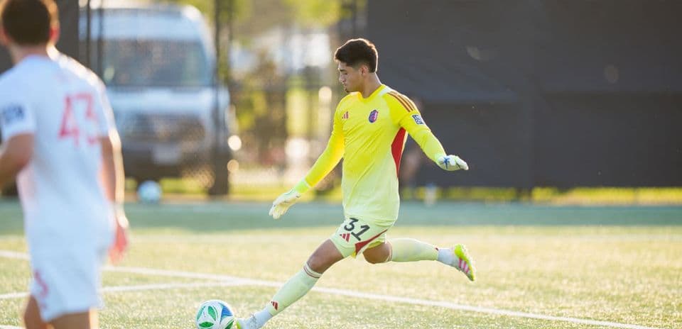 Goalkeeper kicking ball during match
