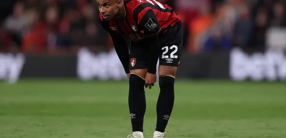 AFC Bournemouth player bending forward on the pitch