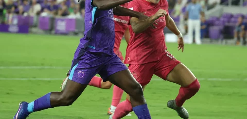 Two players competing for the ball in match