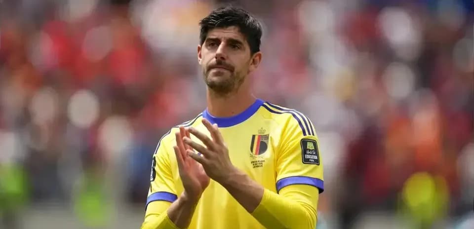 Goalkeeper applauding fans in yellow Belgium jersey