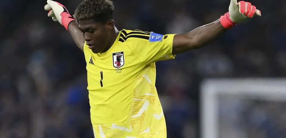 Goalkeeper in yellow kit signaling during match