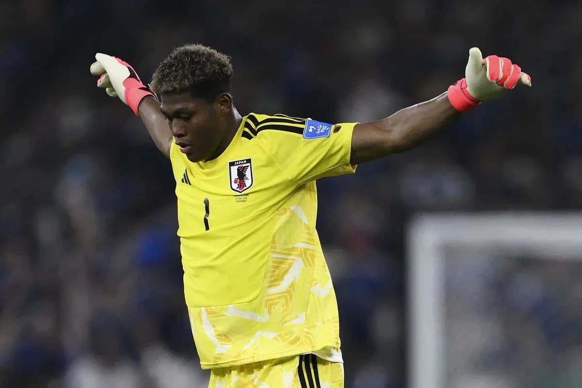 Goalkeeper in yellow kit signaling during match