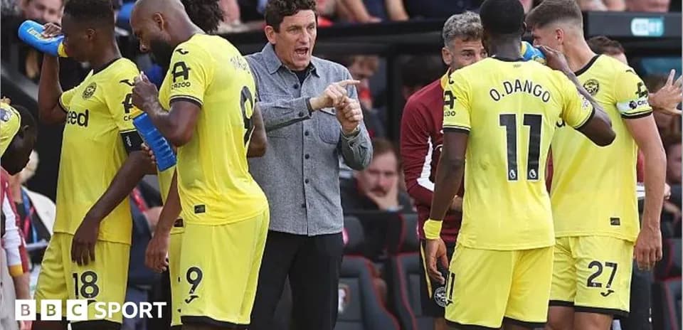 Manager instructing players during a match break