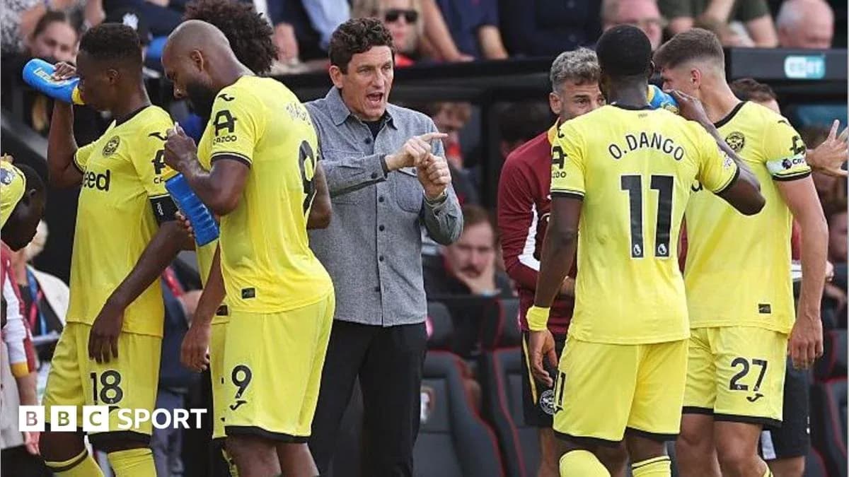 Manager instructing players during a match break