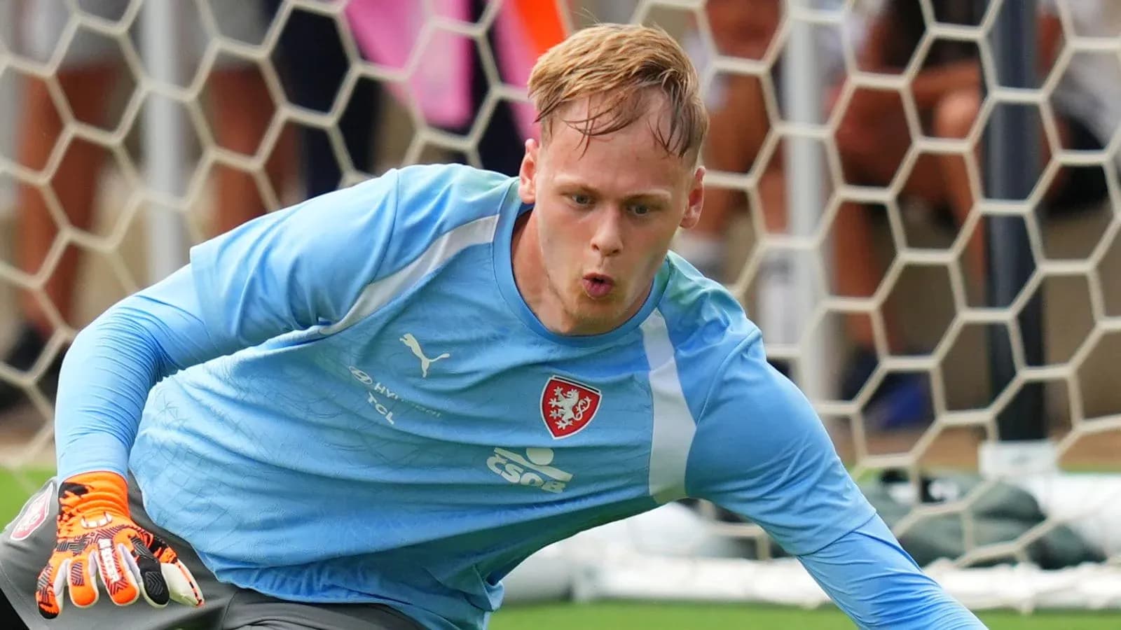 Goalkeeper diving to save a shot during practice