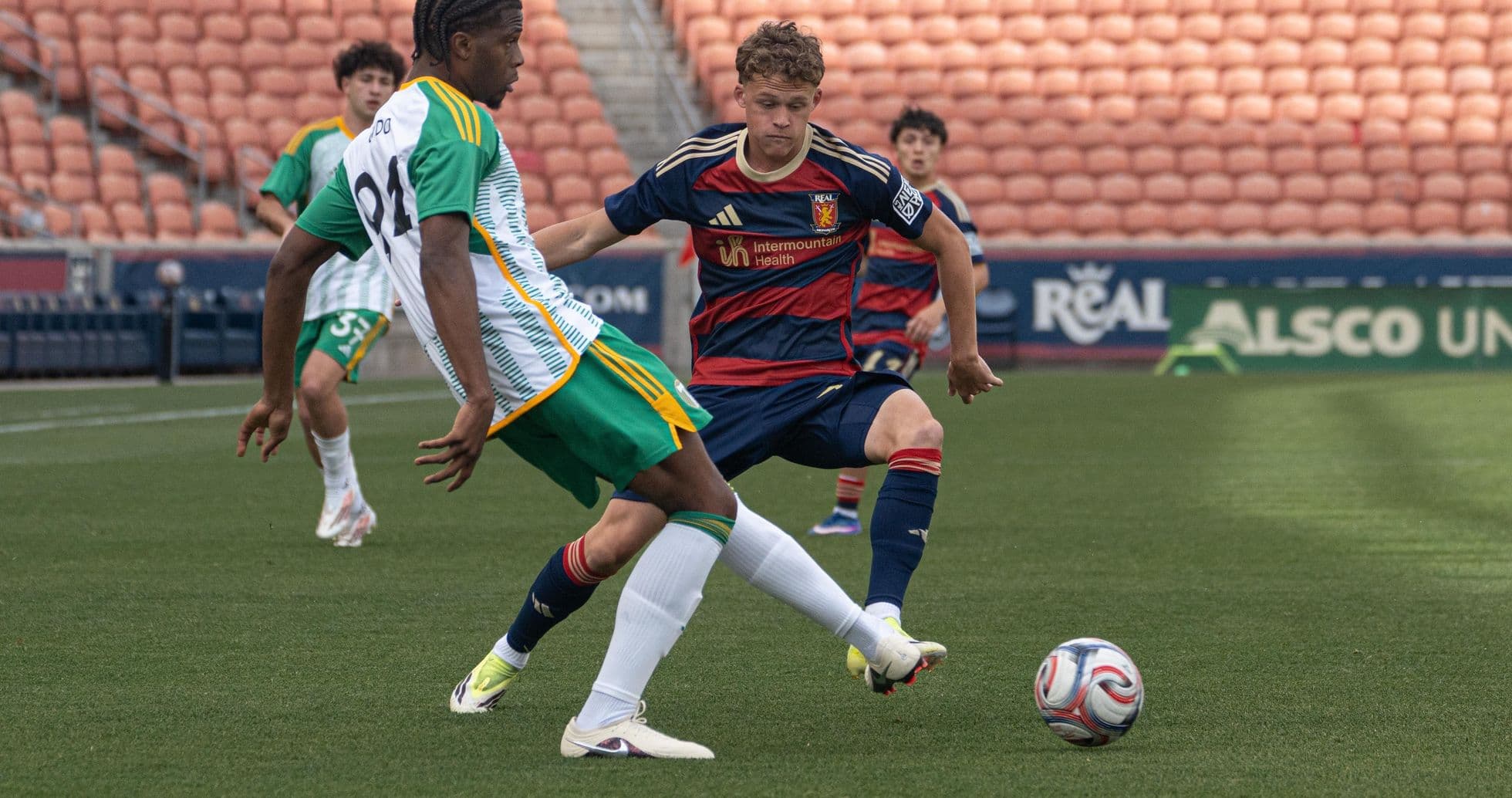Players competing for the ball during match