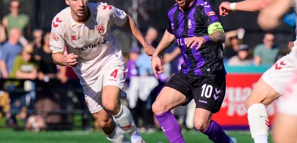 Player dribbling the ball during Cavalry FC match