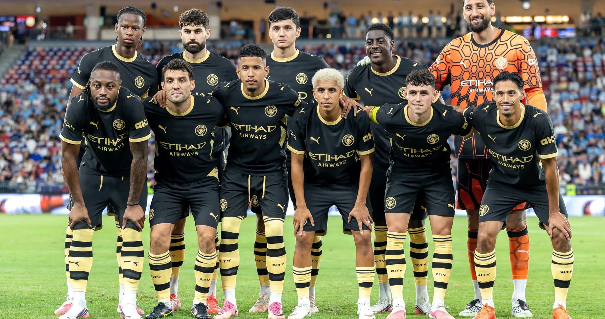 Football team posing for group photo on field