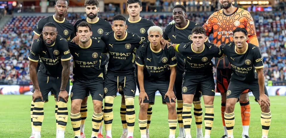 Football team posing for group photo on field