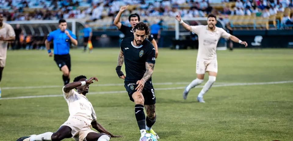 Las Vegas Lights player evading tackle during match