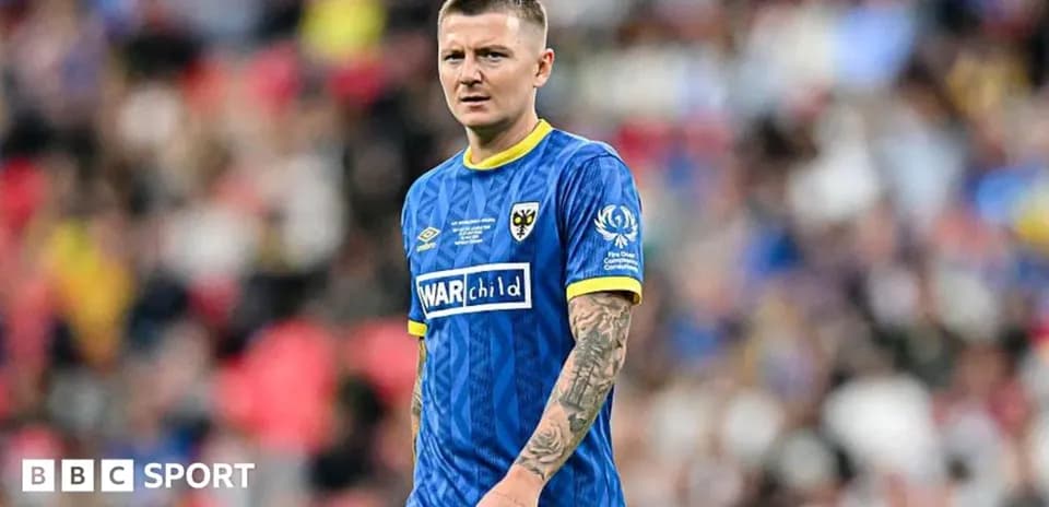 Player in blue kit during a football match