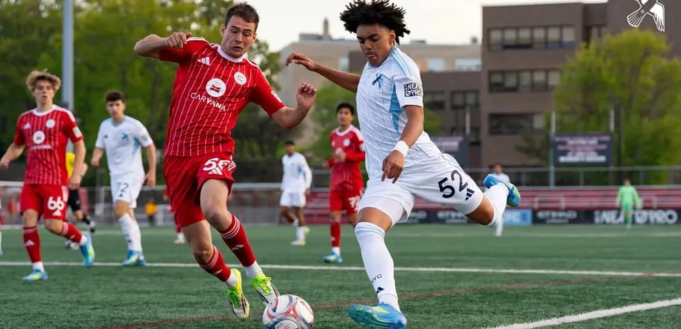 Players competing for the ball in MLS Next Pro match