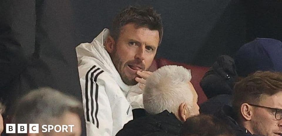 Man in white jacket sitting in the stands