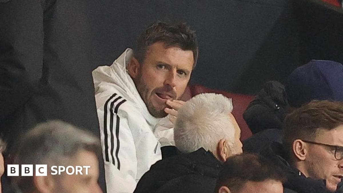 Man in white jacket sitting in the stands