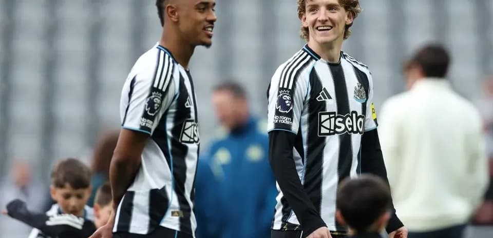 Two Newcastle players smiling during warm-up session