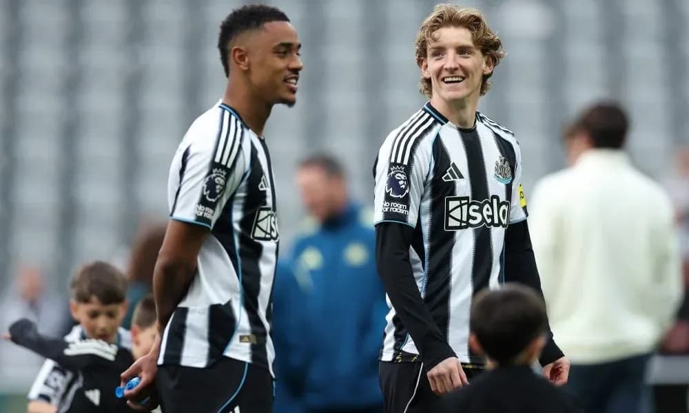 Two Newcastle players smiling during warm-up session