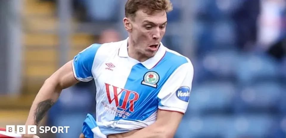 Player in action during match with Blackburn Rovers kit