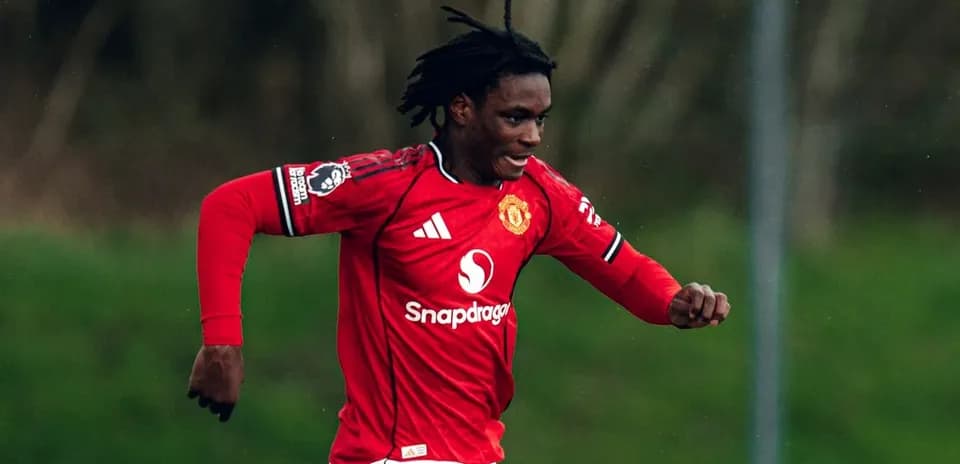 Player running in Manchester United jersey during match