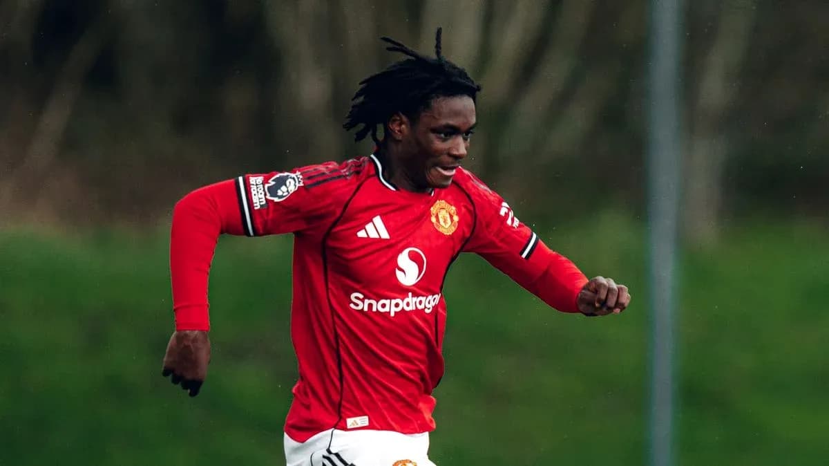 Player running in Manchester United jersey during match