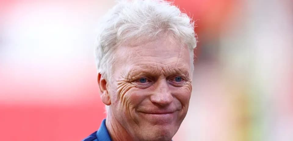 Football manager smiling during pre-match event