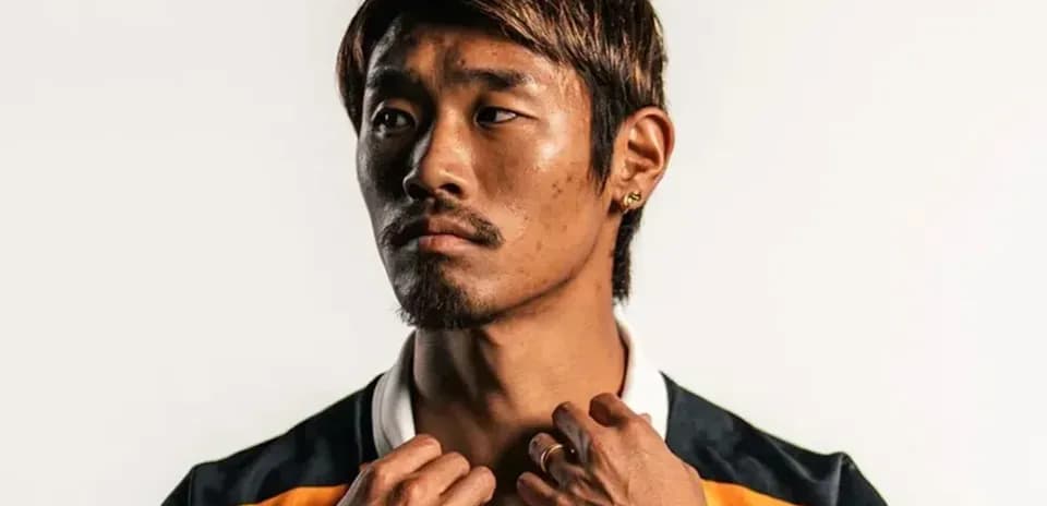 Player posing in sports jersey with serious expression