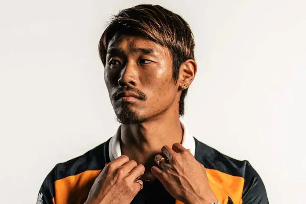 Player posing in sports jersey with serious expression