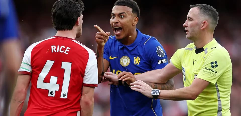 Players arguing during match, referee intervening