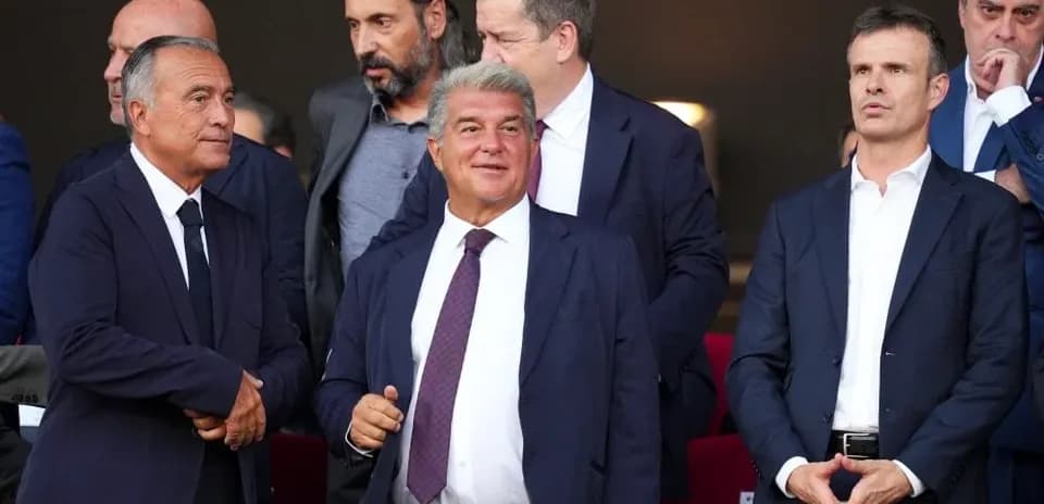 Group of officials in suits at a sporting event