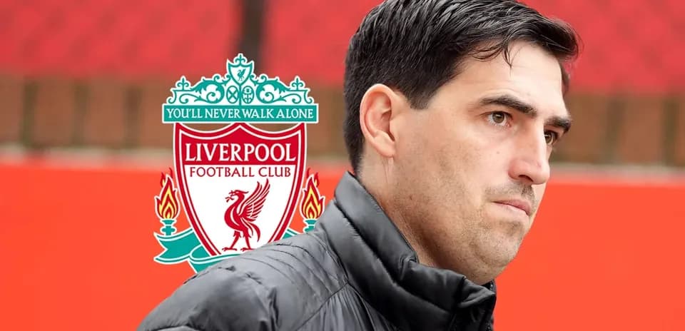 Coach standing in front of Liverpool FC logo